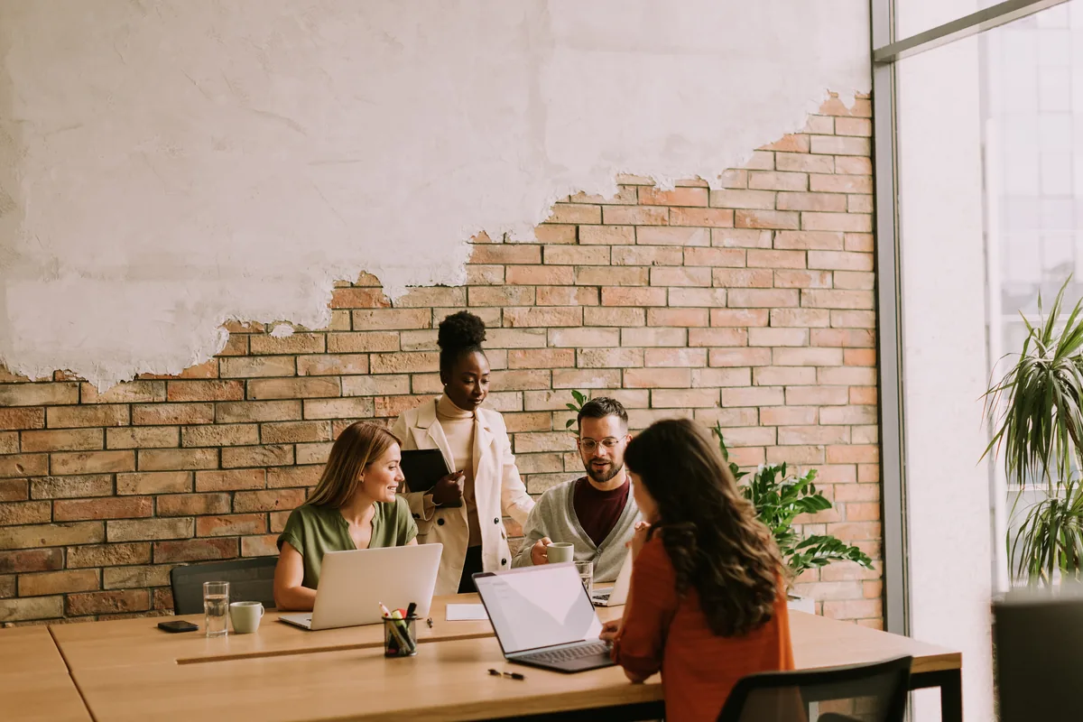 A business team reviewing their work together around a table