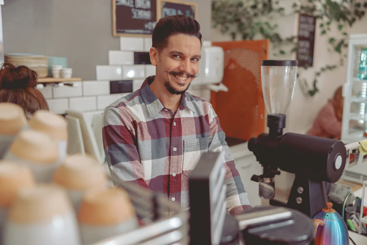 A barista preparing coffee at an espresso machine