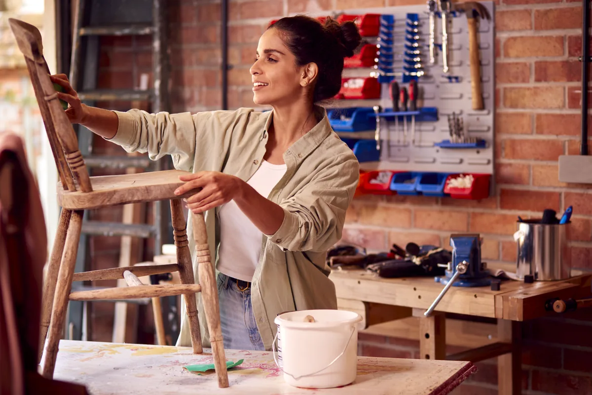 A maker working at a workbench in a small workshop