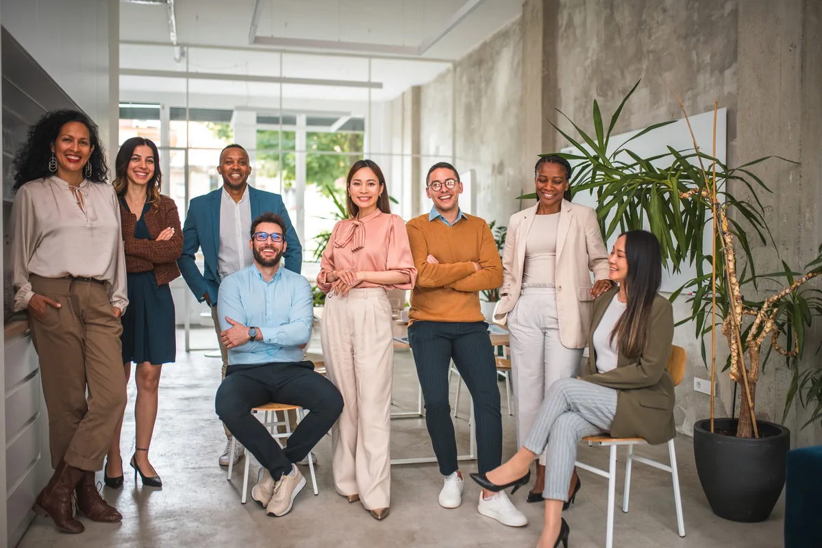 A small business team standing together in their office